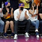 Arizona Cardinals football player JJ Watt, center, cheers on the Phoenix Suns during the first half of Game 5 of an NBA basketball first-round playoff series against the Los Angeles Lakers, Tuesday, June 1, 2021, in Phoenix. (AP Photo/Matt York)
