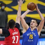 Denver Nuggets center Nikola Jokic (15) shoots against Portland Trail Blazers center Jusuf Nurkic (27) during the first half of Game 5 of a first-round NBA basketball playoff series Tuesday, June 1, 2021, in Denver. (AP Photo/Jack Dempsey)