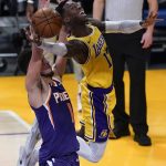 
              Los Angeles Lakers guard Dennis Schroder (17) shoots against Phoenix Suns guard Devin Booker (1) during the second quarter of Game 6 of an NBA basketball first-round playoff series Thursday, Jun 3, 2021, in Los Angeles. (AP Photo/Ashley Landis)
            