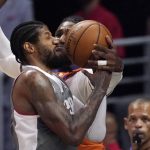 Phoenix Suns forward Jae Crowder, right, blocks the shot of Los Angeles Clippers guard Paul George during the first half in Game 4 of the NBA basketball Western Conference Finals Saturday, June 26, 2021, in Los Angeles. (AP Photo/Mark J. Terrill)
