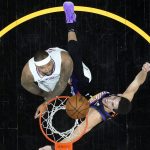 Phoenix Suns guard Devin Booker shoots as Los Angeles Clippers center DeMarcus Cousins, left, defends during the second half of game 5 of the NBA basketball Western Conference Finals, Monday, June 28, 2021, in Phoenix. (AP Photo/Matt York)