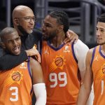 Phoenix Suns head coach Monty Williams, second from left, hugs Chris Paul, left, and Jae Crowder, second from right, as Devin Booker stands by as time runs out in Game 6 of the NBA basketball Western Conference Finals against the Los Angeles Clippers Wednesday, June 30, 2021, in Los Angeles. The Suns won the game 130-103 to take the series 4-2. (AP Photo/Mark J. Terrill)