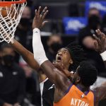 
              Los Angeles Clippers guard Terance Mann, top, shoots as Phoenix Suns center Deandre Ayton defends during the second half in Game 3 of the NBA basketball Western Conference Finals Thursday, June 24, 2021, in Los Angeles. (AP Photo/Mark J. Terrill)
            