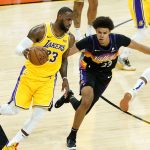 Los Angeles Lakers forward LeBron James, left, drives as Phoenix Suns forward Cameron Johnson defends during the second half of Game 5 of an NBA basketball first-round playoff series, Tuesday, June 1, 2021, in Phoenix. (AP Photo/Matt York)