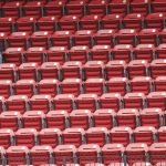 A couple of fans sit amongst rows of empty seats in the sixth inning of a baseball game between the Arizona Diamondbacks and the St. Louis Cardinals, Wednesday, June 30, 2021, in St. Louis. (AP Photo/Tom Gannam)