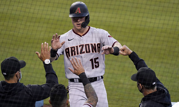Arizona Diamondbacks' Andrew Young is congratulated by teammates after scoring on a double by Nick ...