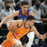 Phoenix Suns guard Devin Booker, front, drives past Denver Nuggets forward Michael Porter Jr. during the second half of Game 3 of an NBA second-round playoff series Friday, June 11, 2021, in Denver. Phoenix won 116-102. (AP Photo/David Zalubowski)