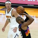 Phoenix Suns guard Chris Paul (3) shoots as Denver Nuggets forward Aaron Gordon (50) looks on during the second half of Game 1 of an NBA basketball second-round playoff series, Monday, June 7, 2021, in Phoenix. (AP Photo/Matt York)