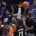 Los Angeles Clippers guard Paul George, right, shoots as Phoenix Suns center Deandre Ayton defends during the first half in Game 6 of the NBA basketball Western Conference Finals Wednesday, June 30, 2021, in Los Angeles. (AP Photo/Mark J. Terrill)