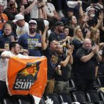 Fans cheer for the Phoenix Suns during the second half of Game 3 of the team's NBA second-round playoff series against the Denver Nuggets on Friday, June 11, 2021, in Denver. Phoenix won 116-102. (AP Photo/David Zalubowski)