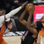 Los Angeles Clippers guard Terance Mann, center, shoots as Phoenix Suns forward Jae Crowder, left, defends during the second half in Game 6 of the NBA basketball Western Conference Finals Wednesday, June 30, 2021, in Los Angeles. (AP Photo/Mark J. Terrill)