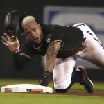 Arizona Diamondbacks Ketel Marte starts to get up after stealing second base during the fourth inning of the team's baseball game against the Los Angeles Dodgers, Saturday, June 19, 2021, in Phoenix. (AP Photo/Rick Scuteri)