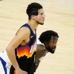 Phoenix Suns guard Devin Booker, left, and Los Angeles Clippers guard Patrick Beverley watch a free throw during the second half of game 5 of the NBA basketball Western Conference Finals, Monday, June 28, 2021, in Phoenix. (AP Photo/Matt York)