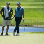 Kramer Hickok, right, smiles alongside his caddie on the eighth green during the first round of the Travelers Championship golf tournament at TPC River Highlands, Thursday, June 24, 2021, in Cromwell, Conn. (AP Photo/John Minchillo)