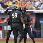 
              Vanderbilt's Jayson Gonzalez (99), center, celebrates with Enrique Bradfield Jr., left, and Javier Vaz, right, after hitting a two-run home run against Arizona in the fourth inning during a baseball game in the College World Series, Saturday, June 19, 2021, at TD Ameritrade Park in Omaha, Neb. (AP Photo/Rebecca S. Gratz)
            