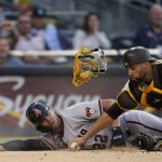 Arizona Diamondbacks' Josh Reddick, left, slides in safely to home, scoring off an RBI double by Eduardo Escobar as San Diego Padres catcher Webster Rivas reaches for the loose ball during the first inning of a baseball game Saturday, June 26, 2021, in San Diego. (AP Photo/Gregory Bull)