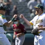 Oakland Athletics relief pitcher Jake Diekman, right, is congratulated by catcher Sean Murphy, left, after a victory over the Arizona Diamondbacks baseball game Wednesday, June 9, 2021, in Oakland, Calif. (AP Photo/Tony Avelar)