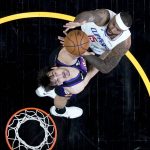 Los Angeles Clippers center DeMarcus Cousins (15) shoots over Phoenix Suns forward Dario Saric during the first half of game 5 of the NBA basketball Western Conference Finals, Monday, June 28, 2021, in Phoenix. (AP Photo/Matt York)
