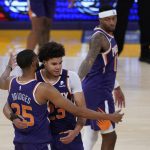 Phoenix Suns forward Mikal Bridges (25) and forward Cameron Johnson (23) celebrate after winning 113-100 over the Los Angeles Lakers of Game 6 of an NBA basketball first-round playoff series Thursday, June 3, 2021, in Los Angeles. The Suns won the series 4-2 and will move on to round 2. (AP Photo/Ashley Landis)