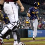 Milwaukee Brewers' Jace Peterson scores on a base hit by teammate Brandon Woodruff during the fifth inning of a baseball game against the Arizona Diamondbacks, Wednesday, June 23, 2021, in Phoenix. (AP Photo/Matt York)
