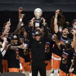 Phoenix Suns head coach Monty Williams, center, hoists the trophy as he and his players celebrate after defeating the Los Angeles Clippers in Game 6 of the NBA basketball Western Conference Finals Wednesday, June 30, 2021, in Los Angeles. (AP Photo/Jae C. Hong)