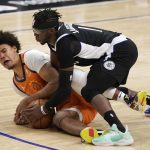 Phoenix Suns forward Cameron Johnson, left, and Los Angeles Clippers guard Reggie Jackson battle for a loose ball during the second half in Game 3 of the NBA basketball Western Conference Finals Thursday, June 24, 2021, in Los Angeles. (AP Photo/Mark J. Terrill)