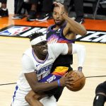 Los Angeles Clippers guard Reggie Jackson drives as Phoenix Suns forward Mikal Bridges, right, defends during the second half of game 5 of the NBA basketball Western Conference Finals, Monday, June 28, 2021, in Phoenix. (AP Photo/Matt York)