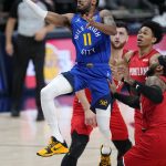Denver Nuggets guard Monte Morris (11) goes up for a shot against the Portland Trail Blazers during the first half of Game 5 of a first-round NBA basketball playoff series Tuesday, June 1, 2021, in Denver. (AP Photo/Jack Dempsey)