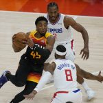 Los Angeles Clippers' Kawhi Leonard (2) and Marcus Morris Sr. (8) defend against Utah Jazz guard Donovan Mitchell (45) during the first half of Game 1 of a second-round NBA basketball playoff series Tuesday, June 8, 2021, in Salt Lake City. (AP Photo/Rick Bowmer)