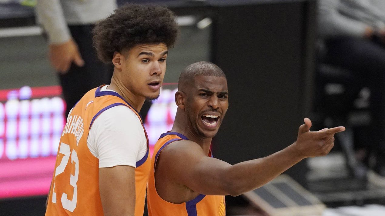 Phoenix Suns guard Chris Paul, right, complains to a referee about a call as forward Cameron Johnso...