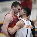 Denver Nuggets center Nikola Jokic, left, argues with Phoenix Suns guard Devin Booker in the second half of Game 4 of an NBA second-round playoff series, Sunday, June 13, 2021, in Denver. (AP Photo/David Zalubowski)