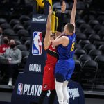 Denver Nuggets center Nikola Jokic (15) shoots over Portland Trail Blazers center Enes Kanter during the second half of Game 5 of a first-round NBA basketball playoff series Tuesday, June 1, 2021, in Denver. (AP Photo/Jack Dempsey)