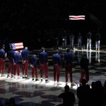 Members of the Phoenix Suns and the Denver Nuggets stand for the playing of the national anthem before Game 4 of an NBA second-round playoff series Sunday, June 13, 2021, in Denver. (AP Photo/David Zalubowski)