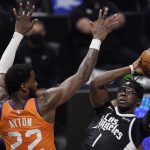 Los Angeles Clippers guard Reggie Jackson, right, shoots as Phoenix Suns center Deandre Ayton defends during the second half in Game 3 of the NBA basketball Western Conference Finals Thursday, June 24, 2021, in Los Angeles. (AP Photo/Mark J. Terrill)