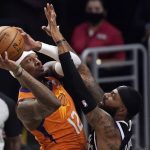 Phoenix Suns forward Torrey Craig, left, shoots as Los Angeles Clippers forward Marcus Morris Sr. defends during the second half in Game 3 of the NBA basketball Western Conference Finals Thursday, June 24, 2021, in Los Angeles. (AP Photo/Mark J. Terrill)