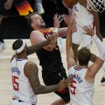Los Angeles Clippers' DeMarcus Cousins (15) and Luke Kennard (5) defend against Utah Jazz guard Joe Ingles during the first half of Game 1 of a second-round NBA basketball playoff series Tuesday, June 8, 2021, in Salt Lake City. (AP Photo/Rick Bowmer)