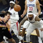 Phoenix Suns forward Dario Saric (20) gt a psss away under pressure from Los Angeles Clippers forward Marcus Morris Sr., right, and guard Reggie Jackson, center, during the second half of game 5 of the NBA basketball Western Conference Finals, Monday, June 28, 2021, in Phoenix. (AP Photo/Matt York)