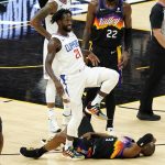 Los Angeles Clippers guard Patrick Beverley (21) smiles after fouling Phoenix Suns guard Chris Paul (3) during the second half of game 5 of the NBA basketball Western Conference Finals, Monday, June 28, 2021, in Phoenix. Beverley was called for a flagrant foul on the play. (AP Photo/Matt York)