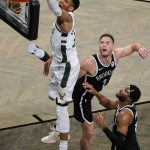 Milwaukee Bucks' Giannis Antetokounmpo, left, dunks in front of Brooklyn Nets' Blake Griffin (2) and Bruce Brown during the second half of Game 7 of a second-round NBA basketball playoff series Saturday, June 19, 2021, in New York. (AP Photo/Frank Franklin II)