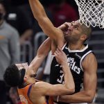 Phoenix Suns guard Devin Booker, left, hits Los Angeles Clippers forward Nicolas Batum in the face as they reach for a rebound during the second half in Game 3 of the NBA basketball Western Conference Finals Thursday, June 24, 2021, in Los Angeles. (AP Photo/Mark J. Terrill)