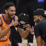 Phoenix Suns guard Cameron Payne, left, celebrates with forward Mikal Bridges after the Suns won Game 6 of the NBA basketball Western Conference Finals against the Los Angeles Clippers Wednesday, June 30, 2021, in Los Angeles. The Suns won the game 130-103 to take the series 4-2. (AP Photo/Mark J. Terrill)