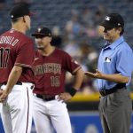 Arizona Diamondbacks manager Torey Lovullo (17) discuses a call with umpire D.J. Reyburn during the fifth inning of a baseball game against the Milwaukee Brewers, Wednesday, June 23, 2021, in Phoenix. (AP Photo/Matt York)