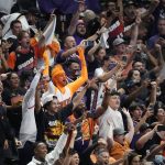 Phoenix Suns fans cheer as time runs out in the second half of Game 4 of an NBA second-round playoff series against the Denver Nuggets, Sunday, June 13, 2021, in Denver. Phoenix won 125-118 to sweep the series. (AP Photo/David Zalubowski)