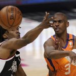 Phoenix Suns guard Chris Paul, right, passes while under pressure from Los Angeles Clippers guard Terance Mann during the first half in Game 3 of the NBA basketball Western Conference Finals Thursday, June 24, 2021, in Los Angeles. (AP Photo/Mark J. Terrill)