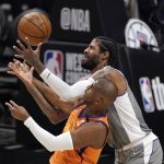Phoenix Suns guard Chris Paul, left, and Los Angeles Clippers guard Paul George reach for a loose ball during the first half in Game 4 of the NBA basketball Western Conference Finals Saturday, June 26, 2021, in Los Angeles. (AP Photo/Mark J. Terrill)