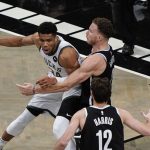 Brooklyn Nets' Blake Griffin, top right, defends against Milwaukee Bucks' Giannis Antetokounmpo (34) during the first half of Game 7 of a second-round NBA basketball playoff series Saturday, June 19, 2021, in New York. (AP Photo/Frank Franklin II)