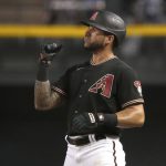 Arizona Diamondbacks' David Peralta reacts after hitting a single against the Los Angeles Dodgers during the eighth inning during a baseball game Saturday, June 19, 2021, in Phoenix. (AP Photo/Rick Scuteri)