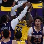 Phoenix Suns forward Jae Crowder (99) defends against Los Angeles Lakers forward LeBron James (23) during the fourth quarter of Game 6 of an NBA basketball first-round playoff series Thursday, June 3, 2021, in Los Angeles. (AP Photo/Ashley Landis)
