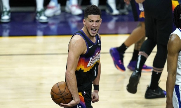 Phoenix Suns guard Devin Booker shouts in celebration in the closing seconds during the second half...