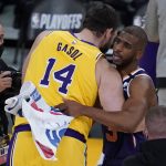 Los Angeles Lakers center Marc Gasol (14) and Phoenix Suns guard Chris Paul (3) hug after Game 6 of an NBA basketball first-round playoff series Thursday, June 3, 2021, in Los Angeles. The Suns won the game 113-100, and the series 4-2. They will move on to round 2. (AP Photo/Ashley Landis)